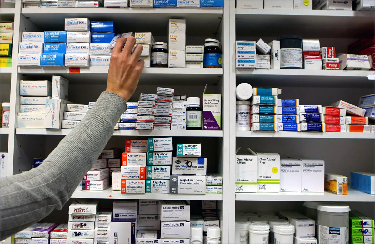 Undated photo of a pharmacist stocking shelves at a chemist. (Julien Behal/PA Wire)