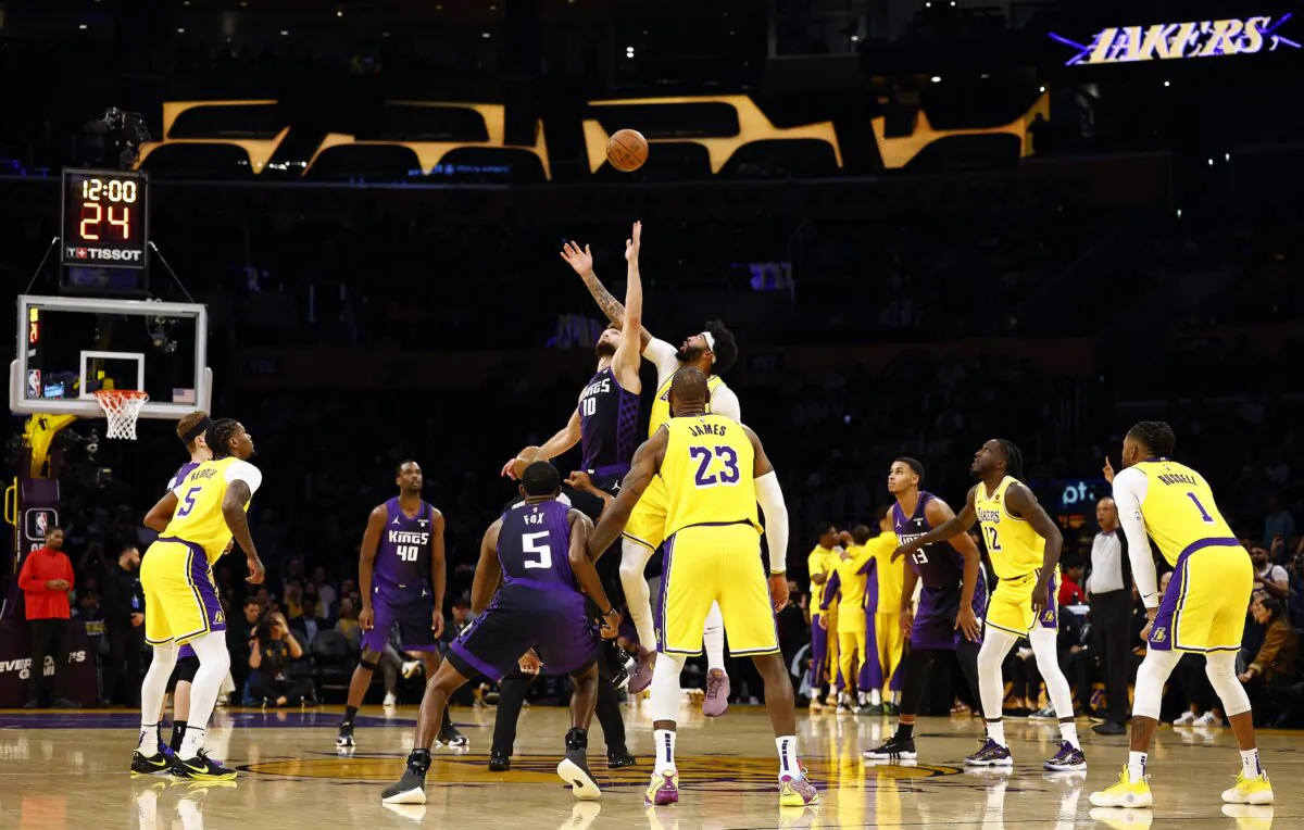 Domantas Sabonis (10) of the Sacramento ings and Anthony Davis (3) of the Los Angeles Lakers on the opening tip in the first quarter in Los Angeles on Nov. 15, 2023. (Ronald Martinez/Getty Images)