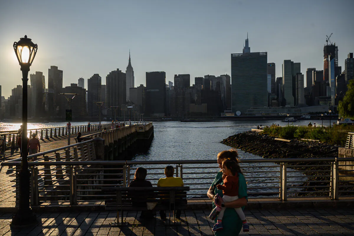 People walk before the United Nations headquarters and the city skyline of New York, in Queens on Sept. 19, 2023, during the 78th United Nations General Assembly. (Photo by ED JONES/AFP via Getty Images)