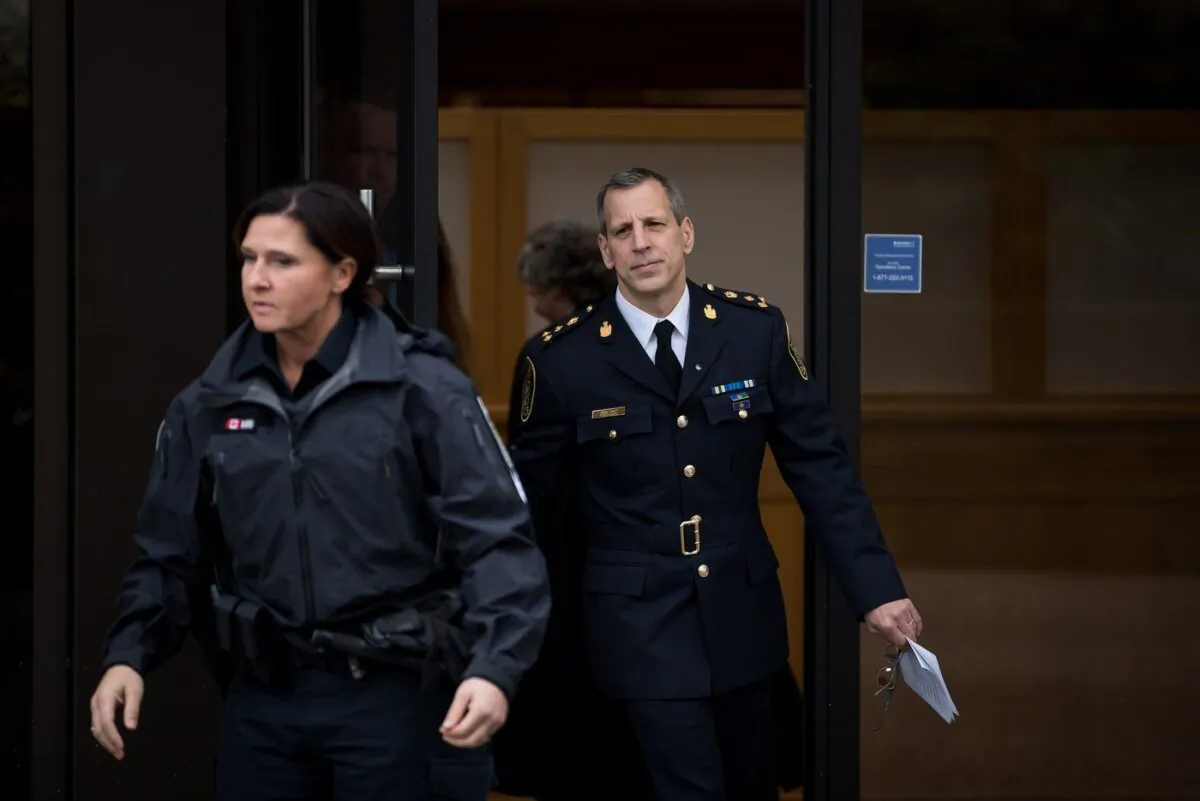 Abbotsford Police Chief Mike Serr, back right, leaves B.C. Supreme Court in New Westminster, B.C., on Feb. 3, 2020.(the Canadian Press/Darryl Dyck)