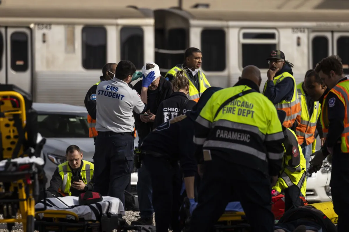 Chicago Fire Department and Chicago Police Department personnel triage patients work the scene after a Chicago Transit Authority train crashed into a piece of equipment that was on the rails near the Howard CTA station on the North Side, in Chicago on Nov. 16, 2023.  (Ashlee Rezin/Chicago Sun-Times via AP)