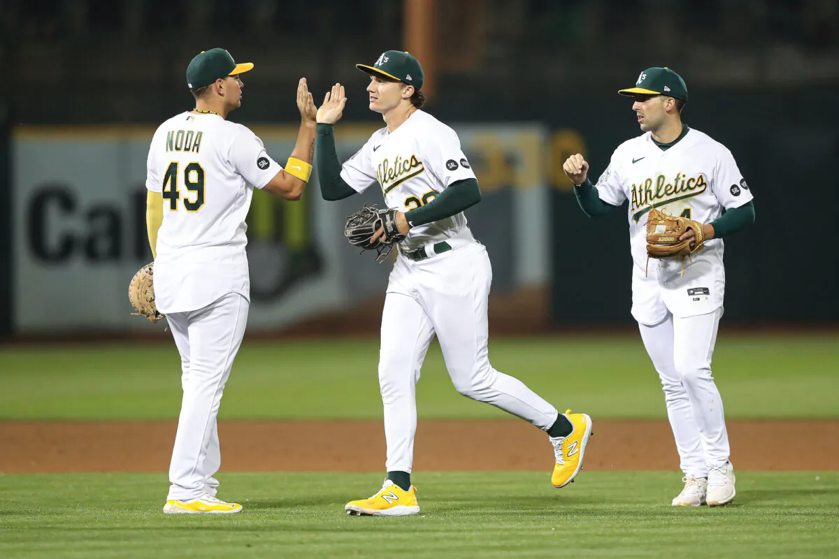 Zack Gelof #20, Ryan Noda #49, and Kevin Smith #4 of the Oakland Athletics celebrate the win against the Detroit Tigers at RingCentral Coliseum in Oakland, Calif., on Sept. 22, 2023. (Kavin Mistry/Getty Images)