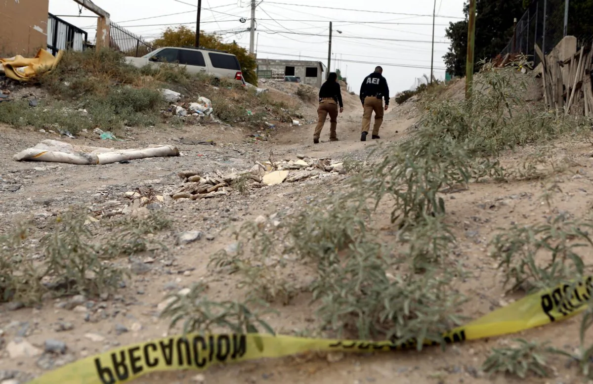 Agents from the Chihuahua Prosecutor's Office check the area where photojournalist Ismael Villagomez was murdered in Ciudad Juarez, state of Chihuahua, Mexico, on Nov 16, 2023. (Herika Martinez/AFP via Getty Images)
