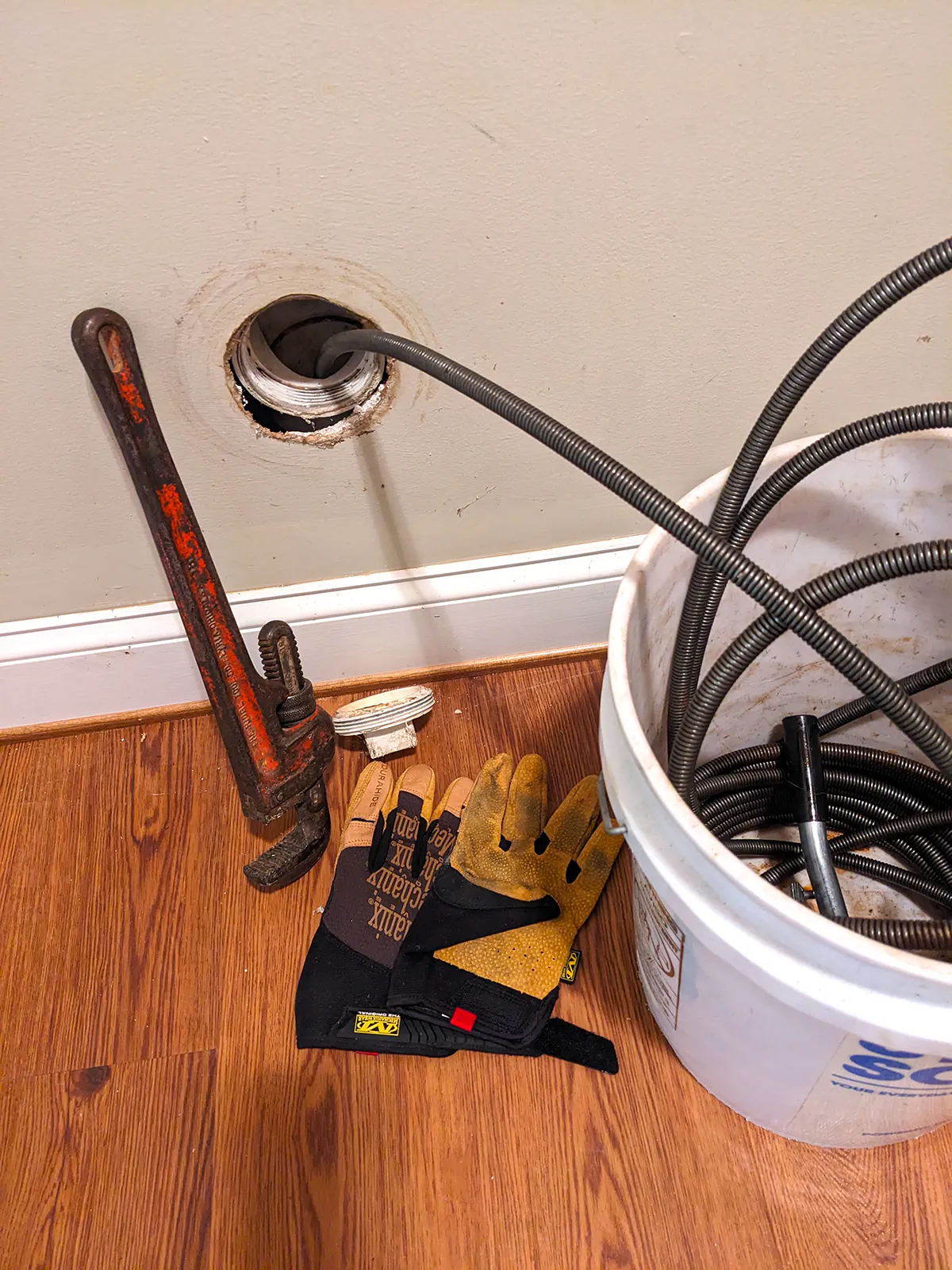 A pipe wrench, an inexpensive 50-foot metal drain-cleaning snake, and some gloves might save your bacon and $500. (Tim Carter/Tribune Content Agency/TNS)