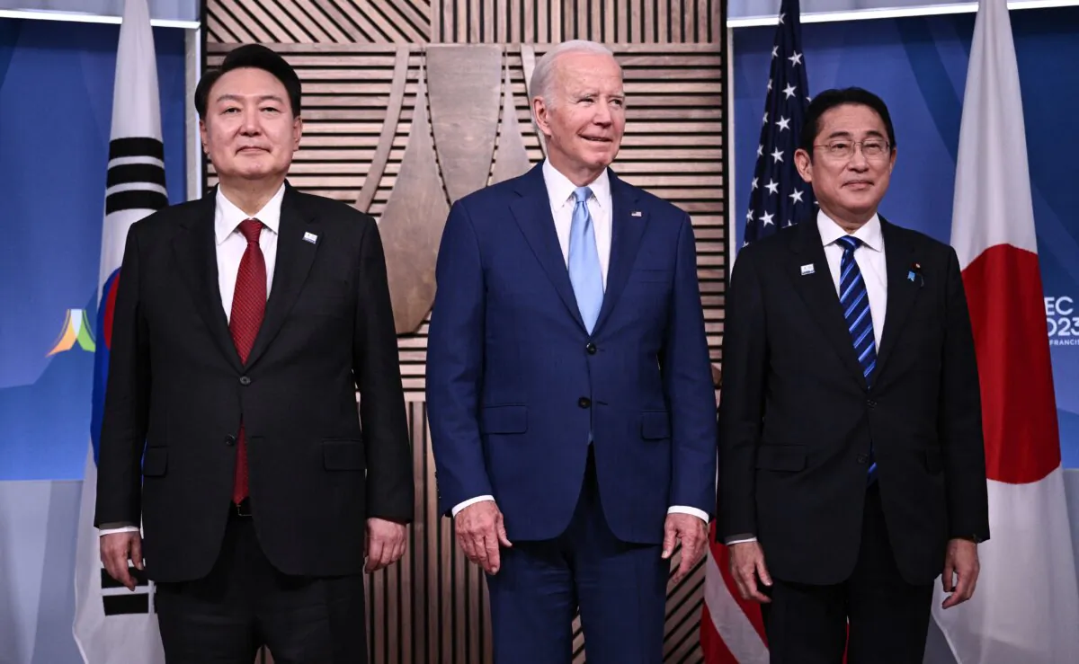 U.S. President Joe Biden, South Korean President Yoon Suk Yeol (L), and Japanese Prime Minister Fumio Kishida (R) stand for a photo ahead of a trilateral meeting at the Asia-Pacific Economic Cooperation (APEC) Leaders' Week in San Francisco, Calif., on Nov. 16, 2023. (Brendan Smialowski / AFP via Getty Images)