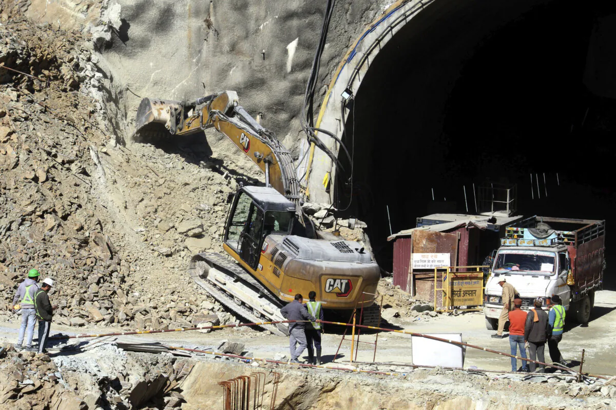 A heavy machinery works at the the entrance to the site of an under-construction road tunnel that collapsed in mountainous Uttarakhand state, India, on Nov. 18, 2023. (AP Photo)