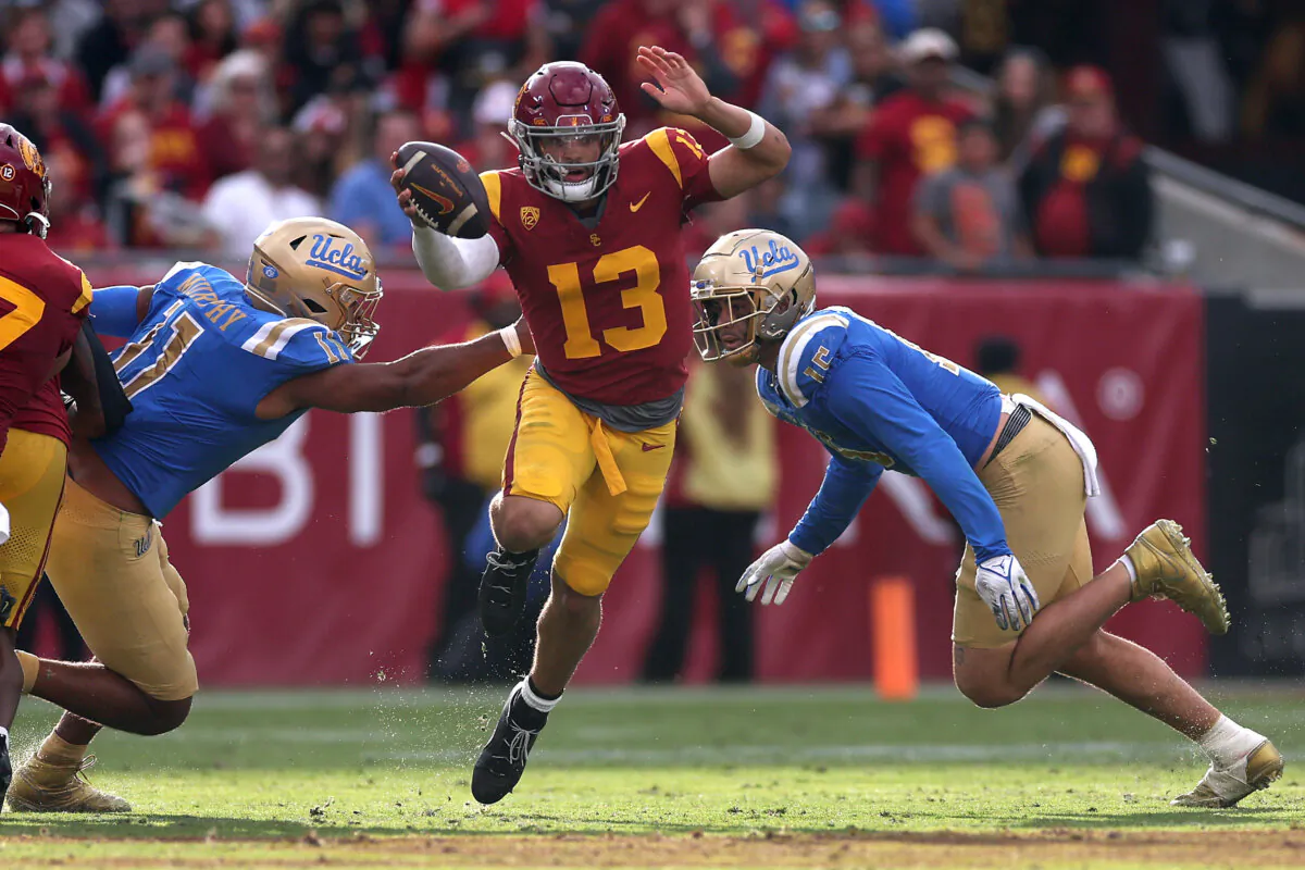 USC quarterback Caleb Williams faces pressure from two UCLA defenders in Los Angeles on Nov. 18, 2023. (Sean M. Haffey/Getty Images)