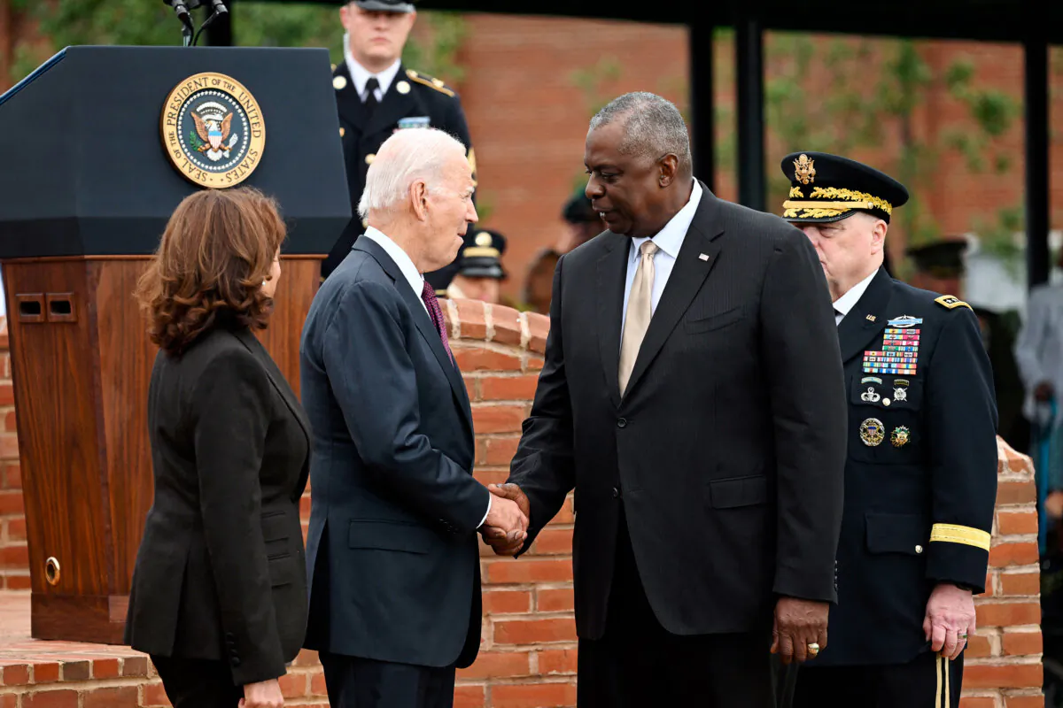 President Joe Biden (C) shakes hands with Defense Secretary Lloyd Austin, as Vice President Kamala Harris stands by, in Arlington, Va., on Sept. 29, 2023. (Saul Loeb/AFP via Getty Images)