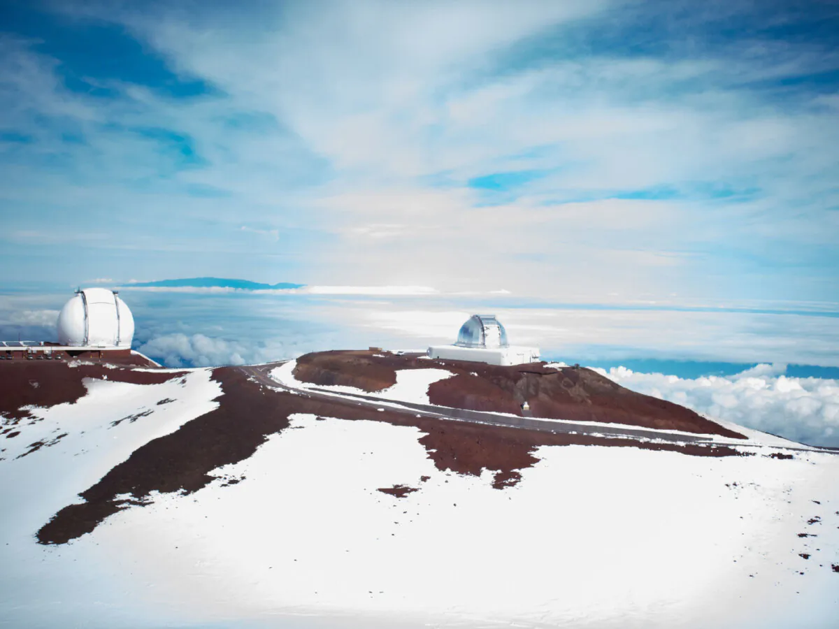Skiers who arrive at the top of Mauna Kea in Hawaii are greeted by the site of telescopes, where astronomers study space from this isolated point. (Wirestock/Dreamstime)