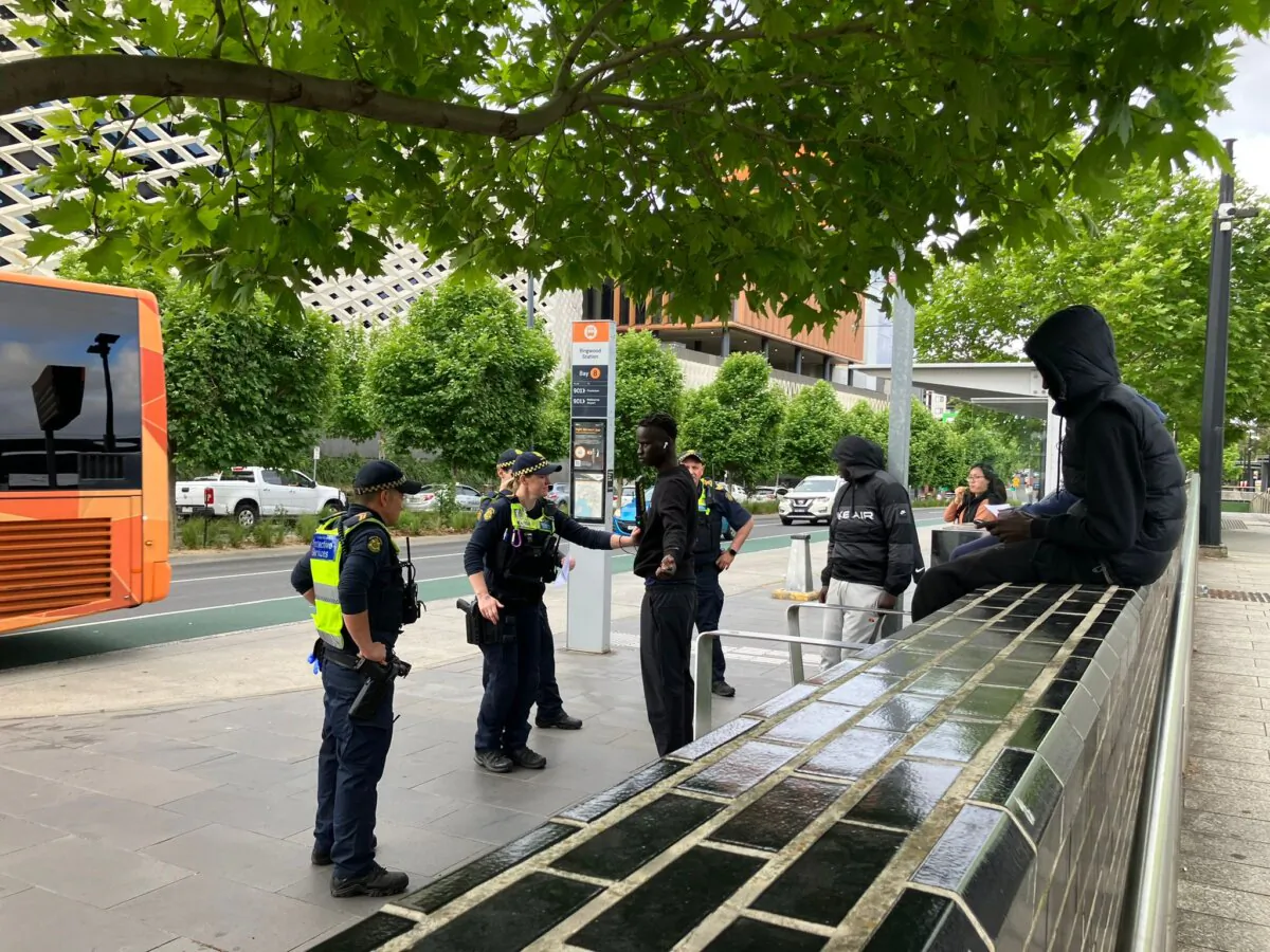 Victoria Police Protective Services officers request to perform body scans on a group of Sudanese Youth gathered in front of Ringwood Train Station in Melbourne, Australia, on Nov. 3, 2023. (The Epoch TImes)