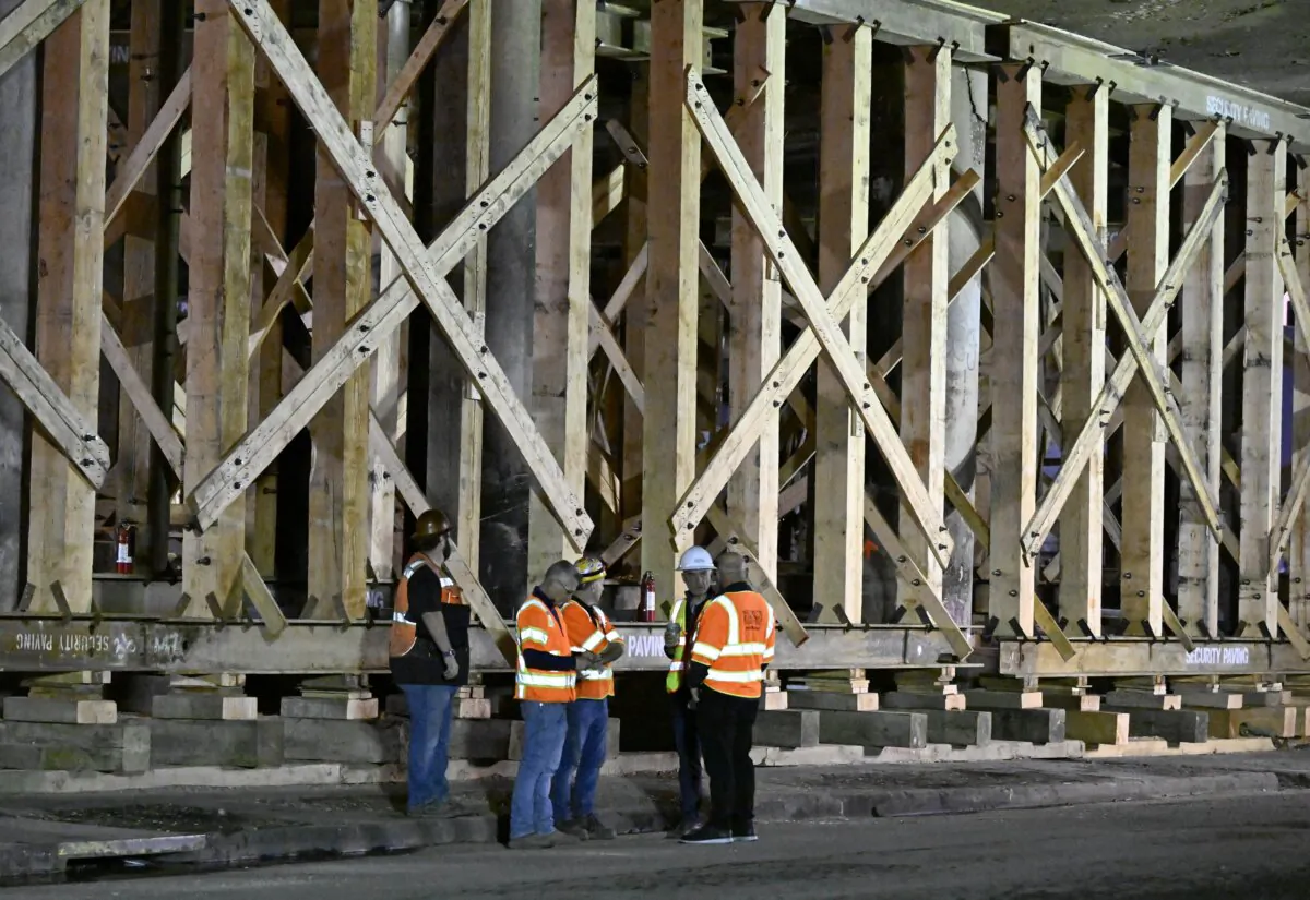 Construction workers gather at the repairs to the I-10 freeway, which was closed by an underpass fire on Saturday, Nov. 11, 2023, in Los Angeles on Nov. 19, 2023. (Alex Gallardo/AP Photo)