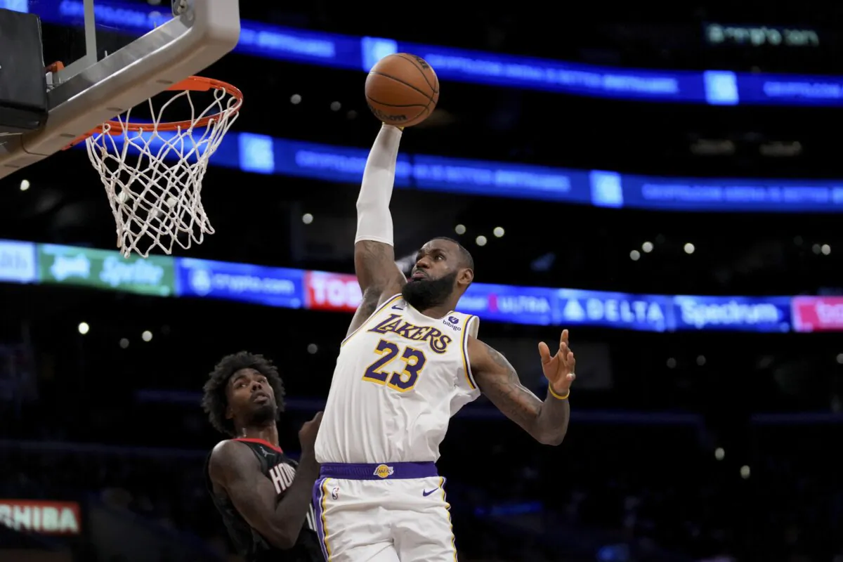 Los Angeles Lakers forward LeBron James (23) dunks over Houston Rockets forward Tari Eason (17) during the second half of an NBA basketball game in Los Angeles on Nov. 19, 2023. (Eric Thayer/AP Photo)