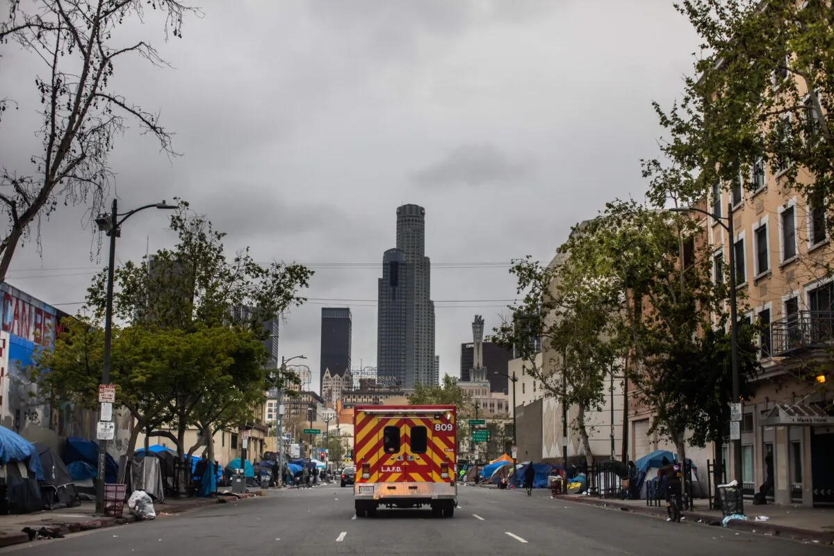 An ambulance drives in downtown Los Angeles on April 12, 2020. (Apu Gomes/AFP via Getty Images)