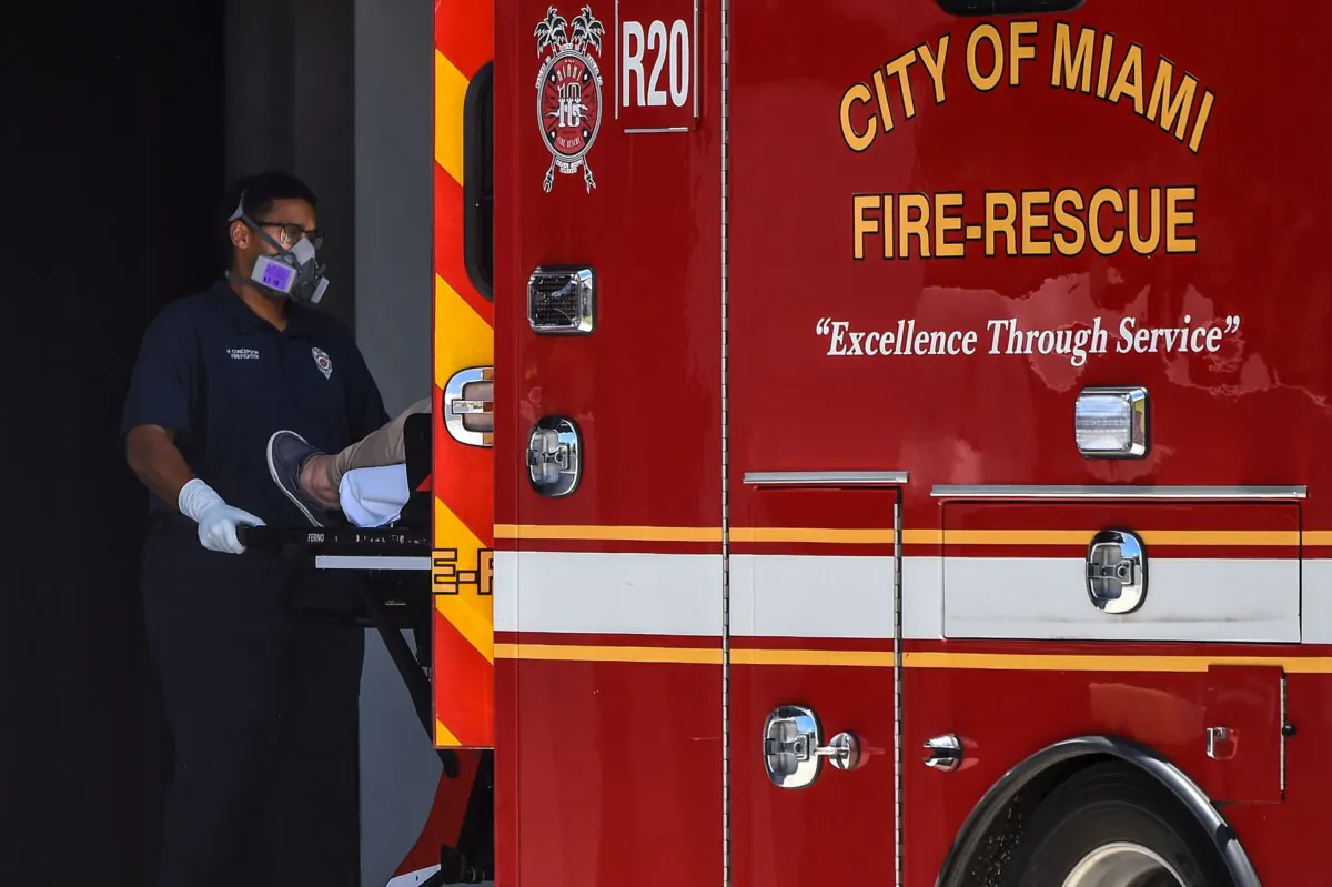 A medic transfers a patient on a stretcher from an ambulance outside Coral Gables Hospital in Coral Gables, Fla. on July 30, 2020. (Chandan Khanna/AFP via Getty Images)
