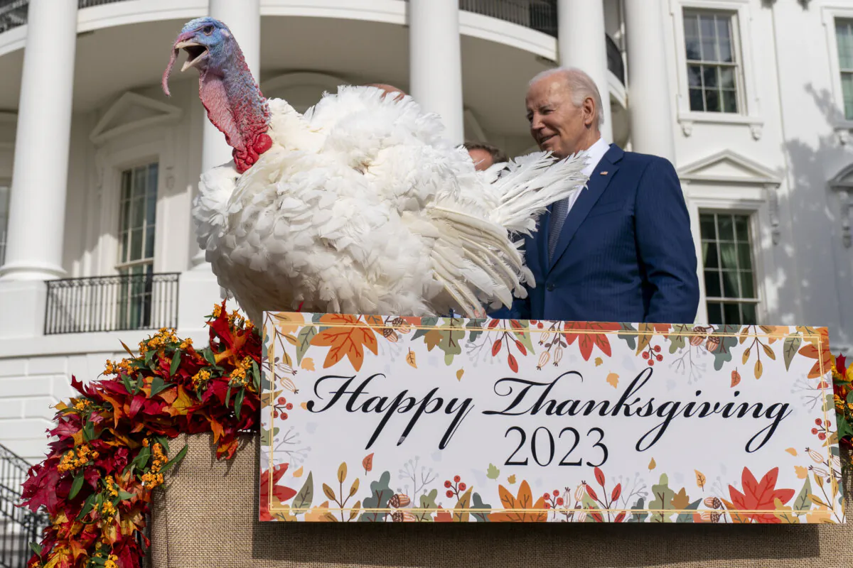 President Joe Biden stands next to Liberty, one of the two national Thanksgiving turkeys, after pardoning them during a ceremony on the South Lawn of the White House on Nov. 20, 2023. (Andrew Harnik/AP Photo)