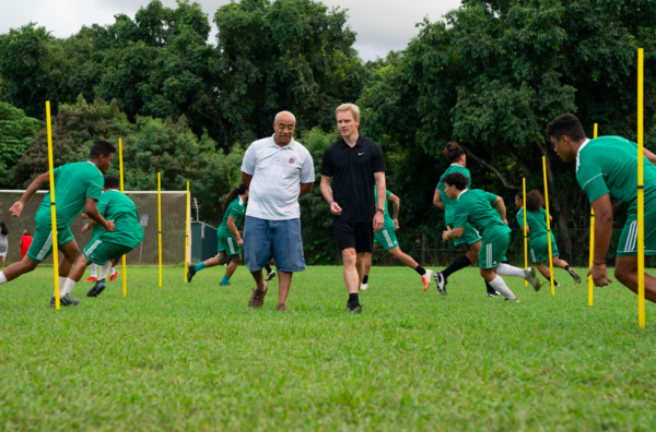 two coaches and soccer in green uniforms in NEXT GOAL WINS