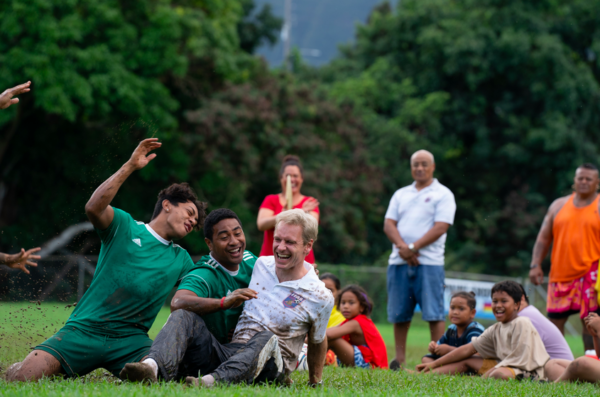men and children having fun on a soccer field in NEXT GOAL WINS