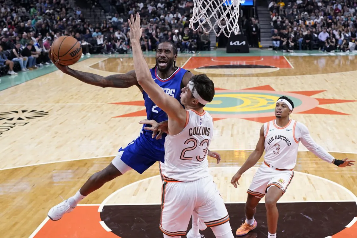 Los Angeles Clippers forward Kawhi Leonard drives to the basket against San Antonio Spurs forward Zach Collins (23) during the second half of an NBA basketball game in San Antonio on Nov. 20, 2023. (Eric Gay/AP Photo)