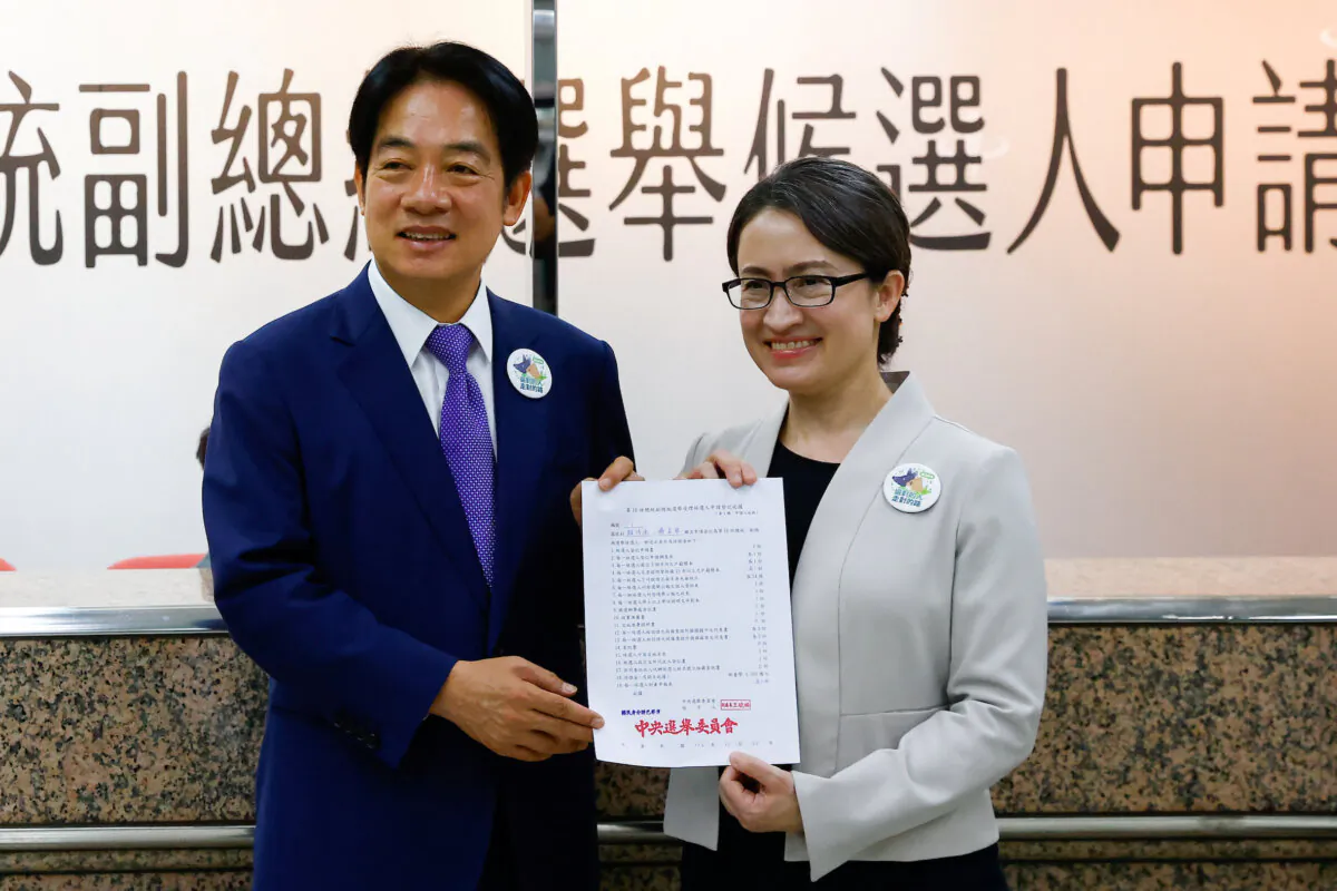 Taiwan's Vice President Lai Ching-te and running mate, Hsiao Bi-Khim, pose for a photo after registering for the upcoming presidential election at the Central Election Commission in Taipei, Taiwan, on Nov. 21, 2023. (Ann Wang/Reuters)