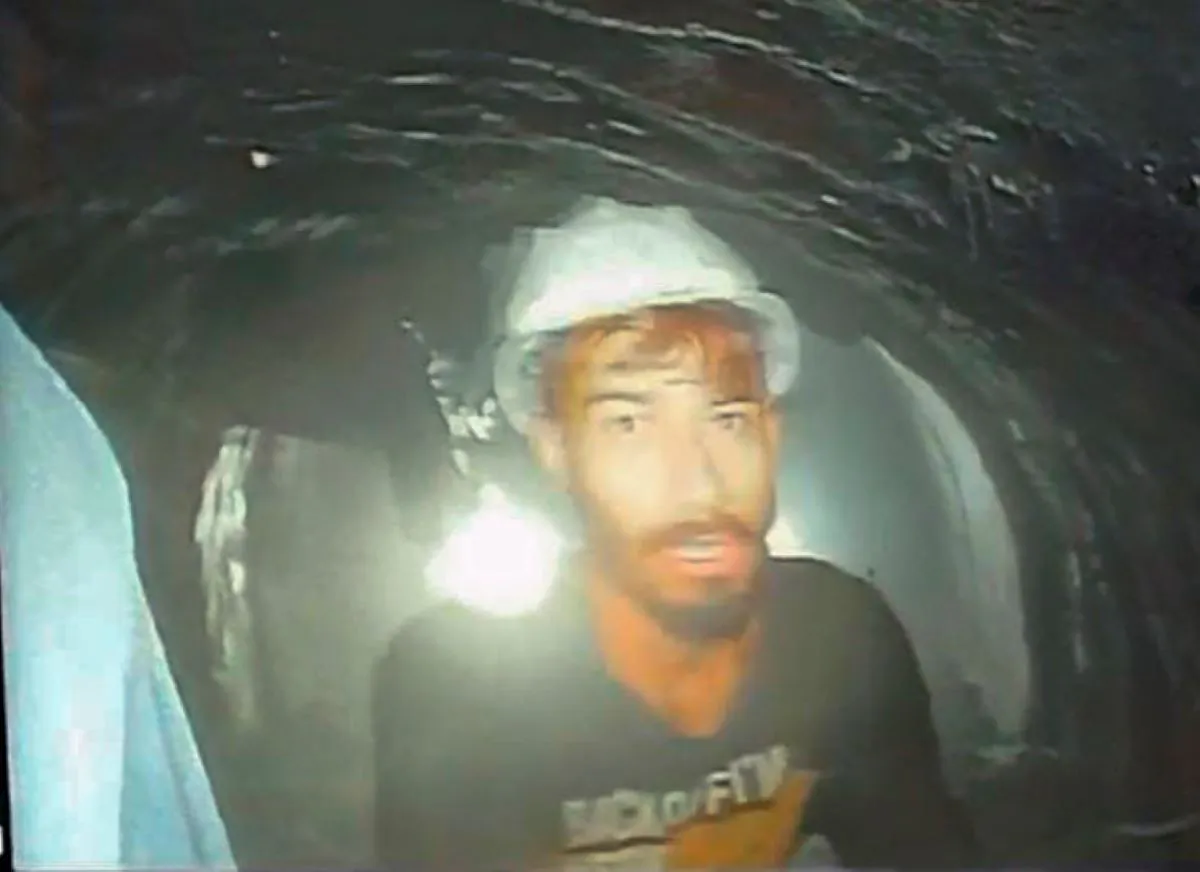 This screen grab image shows one of the 40 workers trapped inside a collapsed tunnel in Silkyara, in the northern Indian Uttarakhand state, India, on Nov. 21, 2023. (The Uttarakhand State Disaster Response Force (SDRF) via AP)