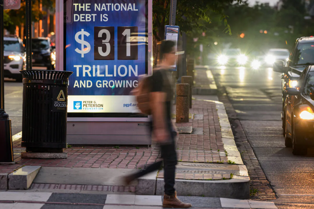 A poster at a bus shelter shows the national debt in Washington on May 21, 2023. (Mandel Ngan/AFP via Getty Images)