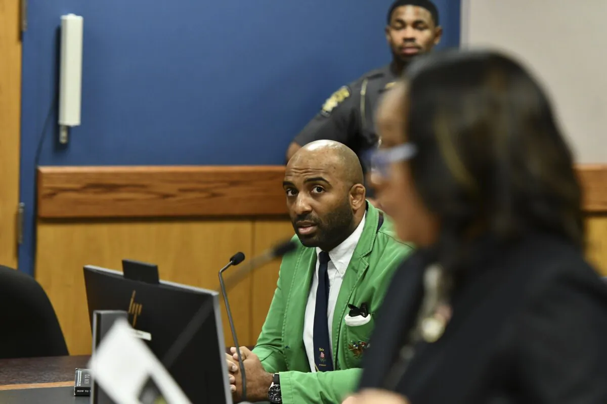 Defendant Harrison Floyd (L), a leader in the organization Black Voices for Trump, listens as Fulton County District Attorney Fani Willis addresses the court during a hearing related to the Georgia election indictments, in Atlanta on Nov. 21, 2023. (Dennis Byron/Hip Hop Enquirer via AP)
