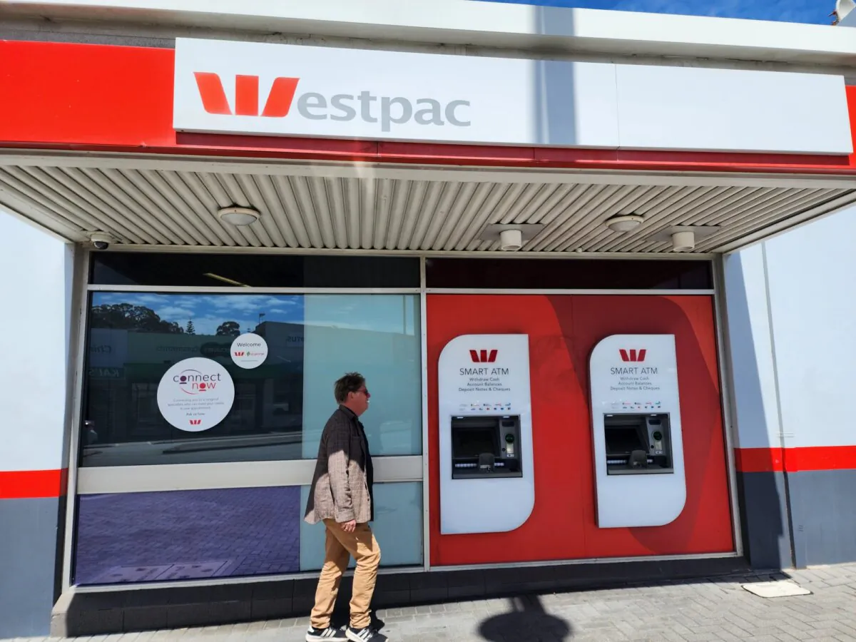 A man walk past ATMs at a regional branch of Westpac bank in Albany, Western Australia, on Nov. 22, 2023. (Susan Mortimer/The Epoch Times)