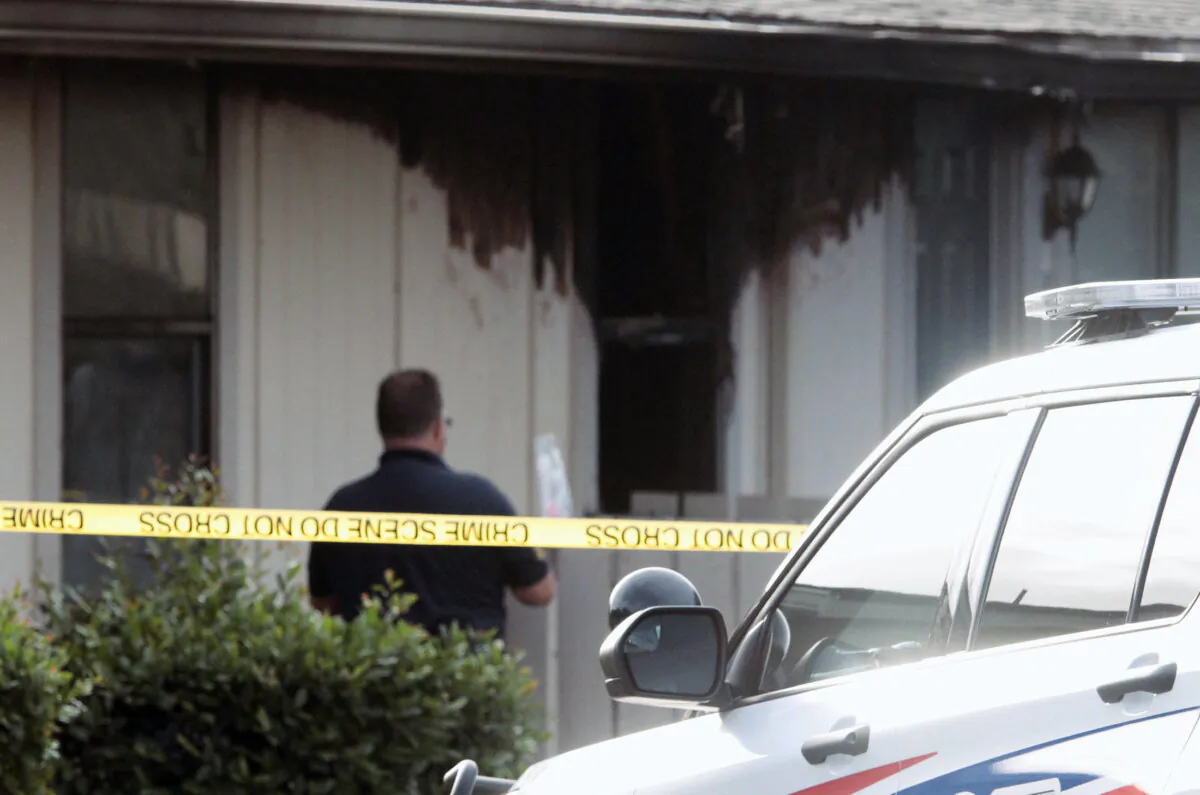 A investigator looks over the fire damaged unit at the Countryside Apartments in Daytona Beach, Fla., on Nov. 21, 2023. (David Tucker/The Daytona Beach News-Journal via AP)