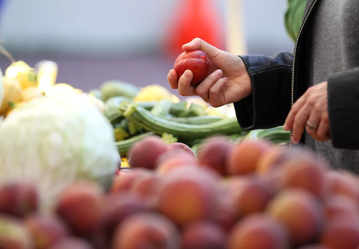A customer shops for nectarines at a farmers market in San Francisco on June 13, 2012. (Justin Sullivan/Getty Images)