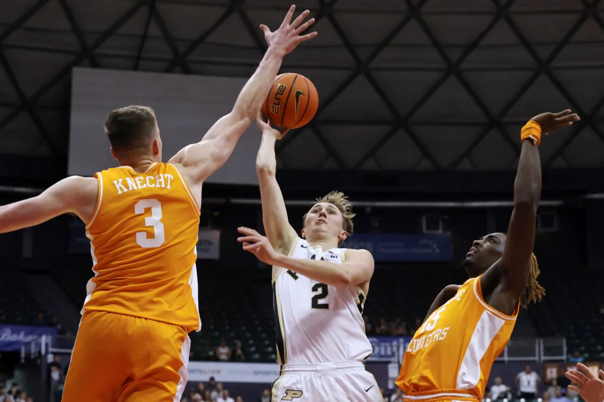 Purdue guard Fletcher Loyer (2) shoots between Tennessee guard Dalton Knecht (3) and guard Jahmai Mashack during the first half of an NCAA college basketball game in Honolulu on Nov. 21, 2023. (Marco Garcia/AP Photo)