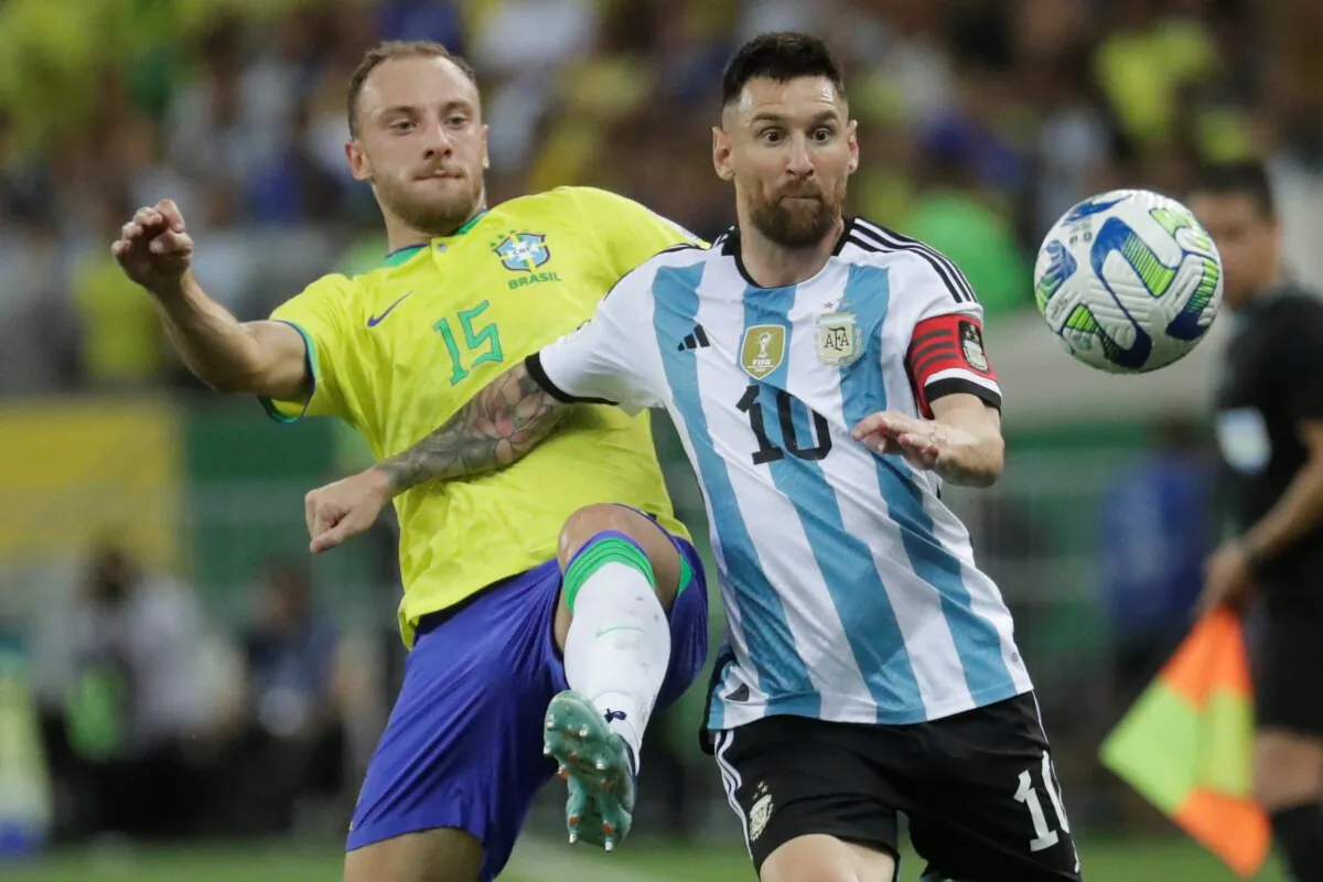 Argentina's Lionel Messi (R), and Brazil's Carlos Augusto battle for the ball during a qualifying soccer match for the FIFA World Cup 2026 at Maracana stadium in Rio de Janeiro, Brazil, on Nov. 21, 2023. (Bruna Prado/AP Photo)