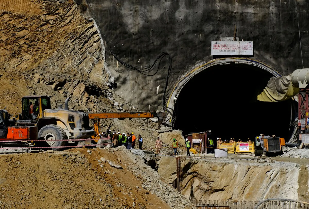 Heavy machinery moves outside a tunnel where 40 road workers are trapped after a portion of the tunnel collapsed in Uttarkashi in the northern state of Uttarakhand, India, on Nov. 16, 2023. (Shankar Prasad Nautiyal/Reuters)