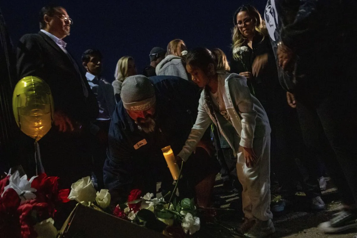 A makeshift memorial for a high school student lines a fence along an alleyway near Rancho High School in eastern Las Vegas on Nov. 21, 2023. (Ty ONeil/AP Photo)