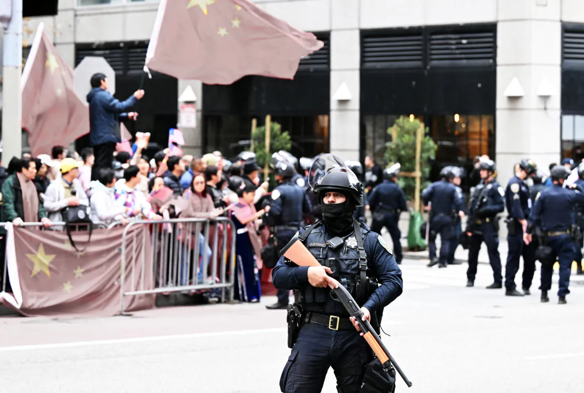 Police stand guard as pro-China and anti-communist protesters line the streets at the Asia-Pacific Economic Cooperation summit in San Francisco on Nov.15, 2023. (JOSH EDELSON/AFP via Getty Images)