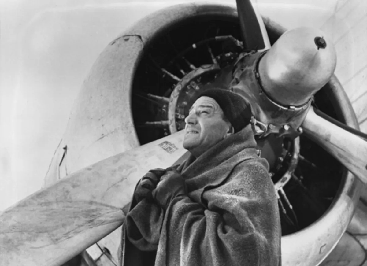 Capt. Dooley (John Wayne) must hold his grounded flight crew until help hopefully arrives, in “Island in the Sky.” (Warner Bros)