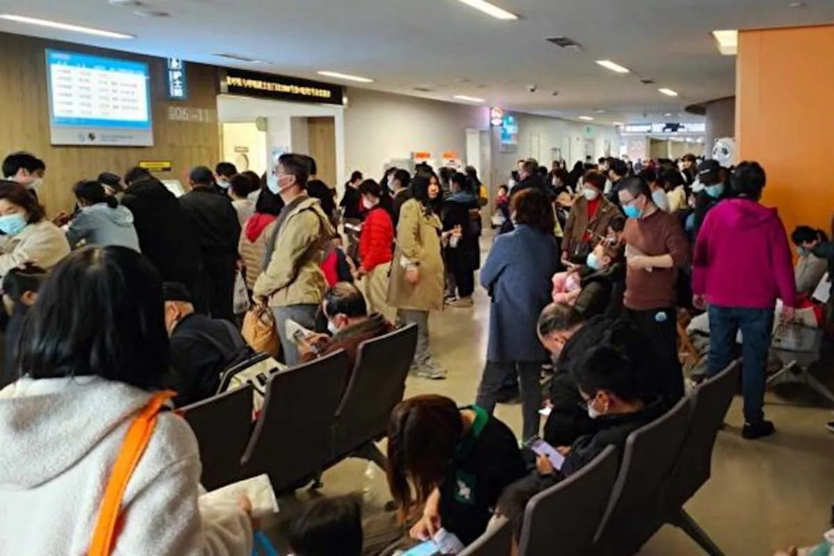 Parents and children wait to see a doctor at a pediatric clinic of Xinhua Hospital Affiliated to Shanghai Jiaotong University School of Medicine as influenza A outbreaks in Shanghai, China, on March 6, 2023. (Wang Gang/VCG via Getty Images)
