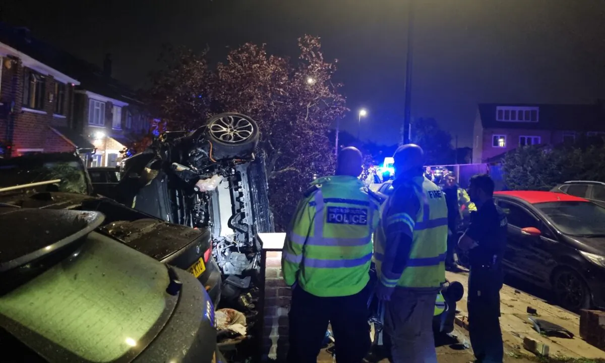 Police officers inspect the wreckage of a stolen Range Rover which car thief Aidas Poskus crashed while being chased by police in west London on Sep. 26, 2023. (The Epoch Times)