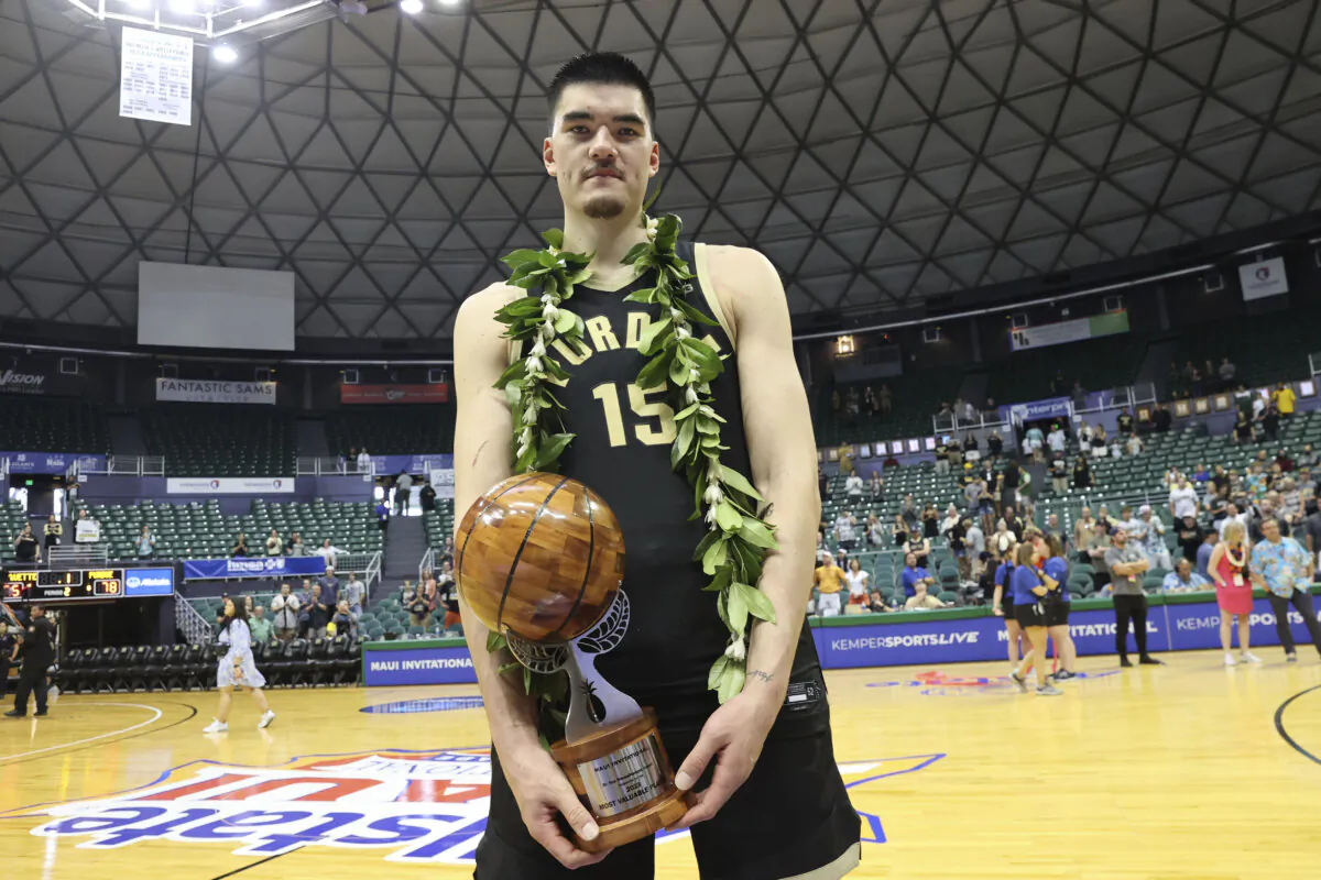 Purdue center Zach Edey (15) holds the MVP award after an NCAA college basketball game in Honolulu on Nov. 22, 2023. (Marco Garcia/AP Photo)