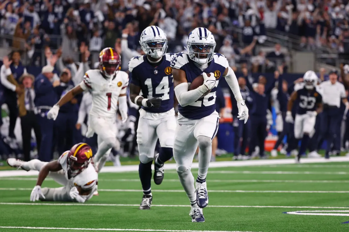 DaRon Bland (26) of the Dallas Cowboys returns an interception for a touchdown in the game against the Washington Commanders during the fourth quarter in Arlington, Texas, on Nov. 23, 2023. (Richard Rodriguez/Getty Images)