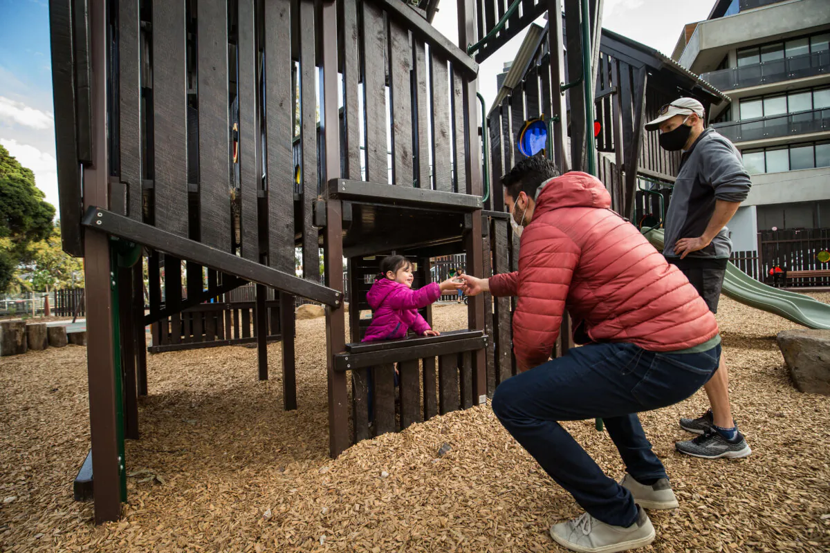 Parent and children enjoy time at a playground in Brunswick in Melbourne, Australia, on Sept. 3, 2021. (Darrian Traynor/Getty Images)