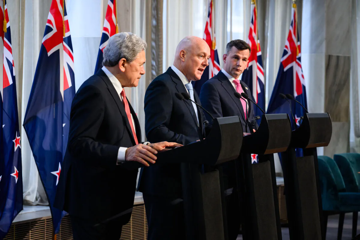 (L-R) Winston Peters, leader of NZ First party, New Zealand Prime Minister Christopher Luxon of the centre-right National Party, and David Seymour, leader of the libertarian-ACT New Zealand party, attend the signing of an agreement to form a three-party coalition government at Parliament in Wellington on Nov. 24, 2023. (Marty Melville/AFP via Getty Images)
