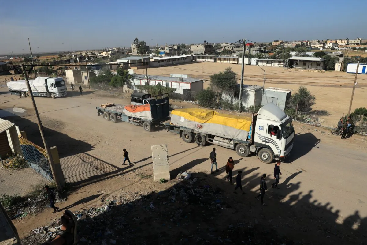 Trucks carrying humanitarian aid enter the Gaza Strip via the Rafah crossing with Egypt, hours after the start of a four-day truce between Israel and Hamas, on Nov. 24, 2023. (Said Khatib/AFP via Getty Images)