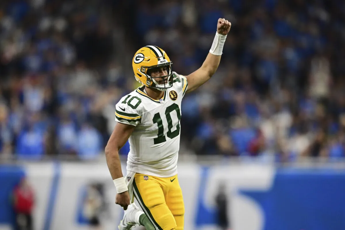 Green Bay Packers quarterback Jordan Love runs up field after throwing a touchdown to wide receiver Christian Watson during the second half of an NFL football game against the Detroit Lions in Detroit on Nov. 23, 2023. (David Dermer/AP Photo)