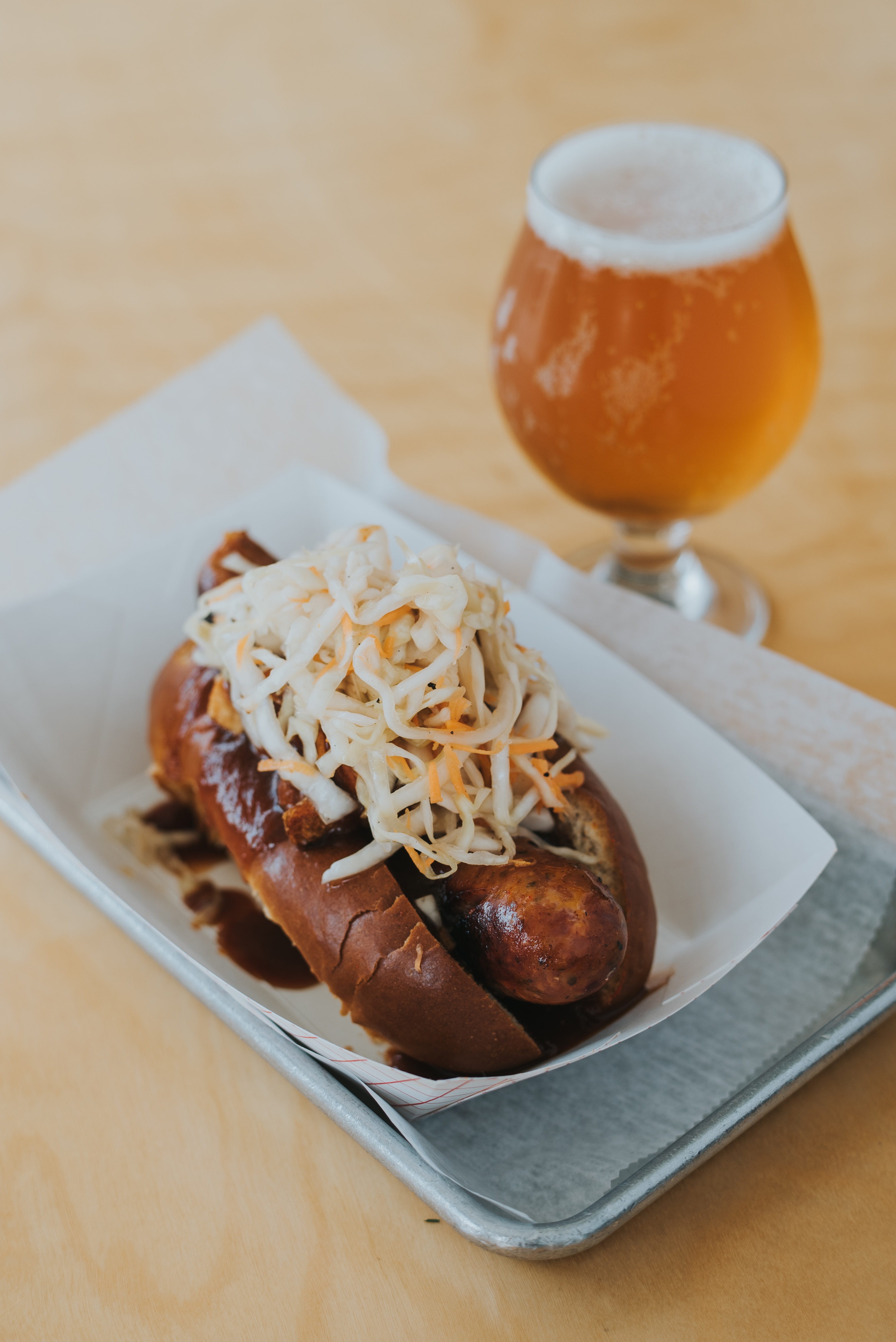 This sausage in a bun covered with coleslaw, French fries, and barbecue sauce should be on your shortlist to try on a visit to Cleveland. (Nathan Migal)