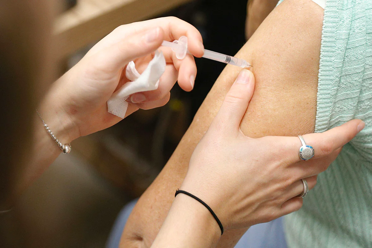 A woman receives a dose of Comirnaty vaccine at a pharmacy in Ajaccio, France, on Oct. 5, 2023. (Pascal Pochard-Casabianca/AFP via Getty Images)