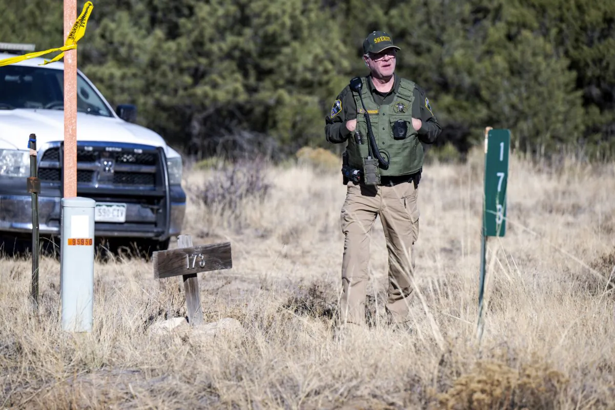 A member of the Custer County Sheriff's Office works the scene of a shooting near Westcliffe, Colo., on Nov. 21, 2023. (Parker Seibold/The Gazette via AP)