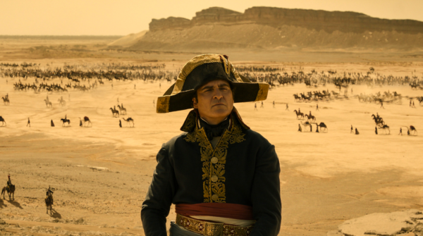 man with hat stands in desert in NAPOLEON