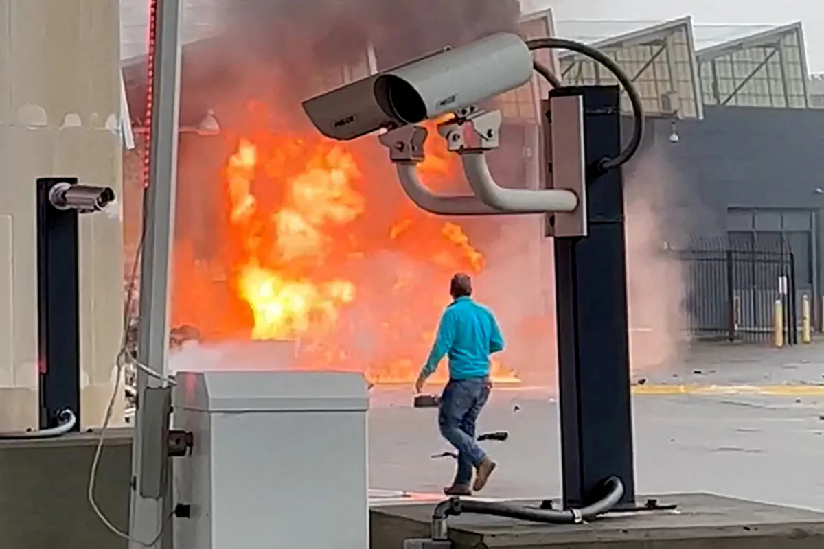 A vehicle burns at the Rainbow Bridge U.S. border crossing with Canada, in Niagara Falls, N.Y., on Nov. 22, 2023, in a still image from video. (Courtesy of Saleman Alwishah via Reuters)