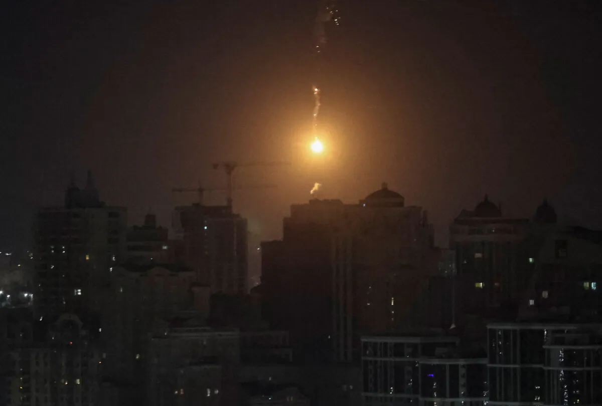 An explosion of a drone is seen in the sky over the city during a Russian drone strike, Ukraine, on Nov. 25, 2023. (Gleb Garanich/Reuters)