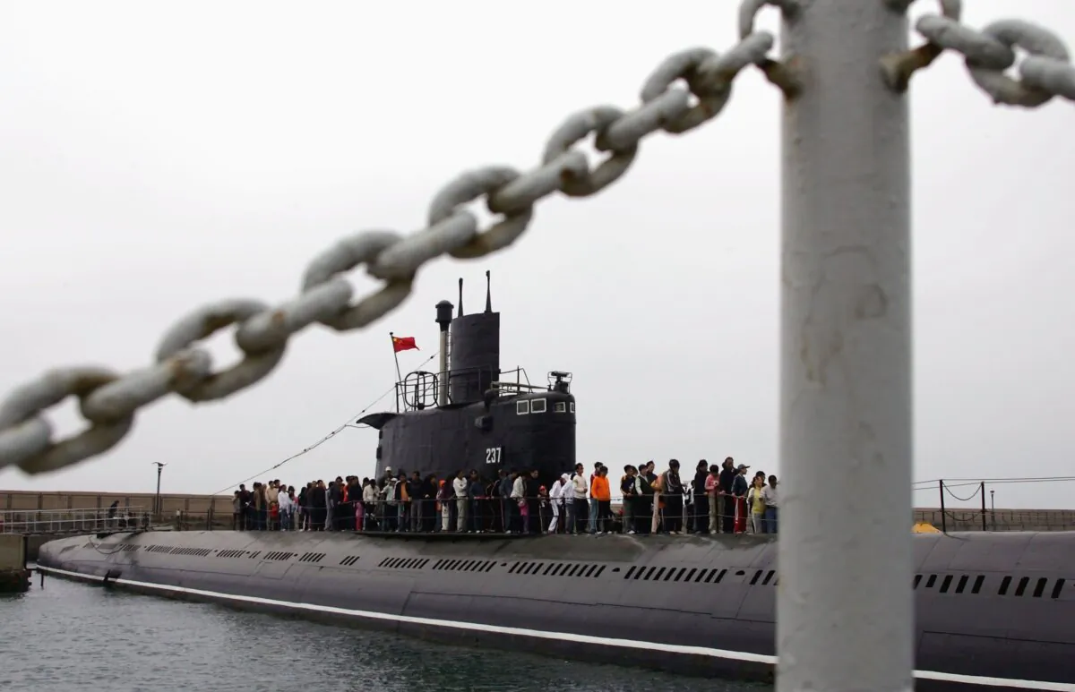 Tourists line up to visit a submarine at the Qingdao Naval Museum in Qingdao of Shandong Province, China, on May 3, 2006. (China Photos/Getty Images)